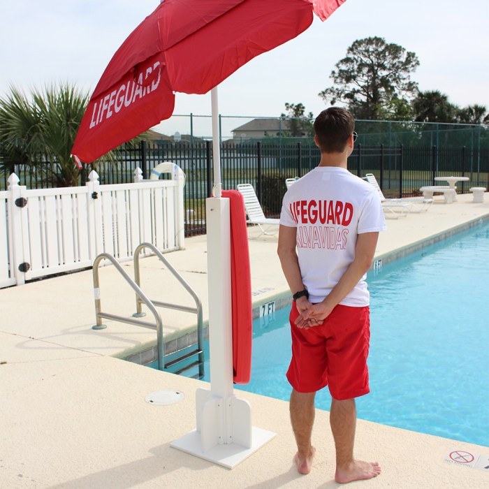 A lifeguard is sitting on a platform